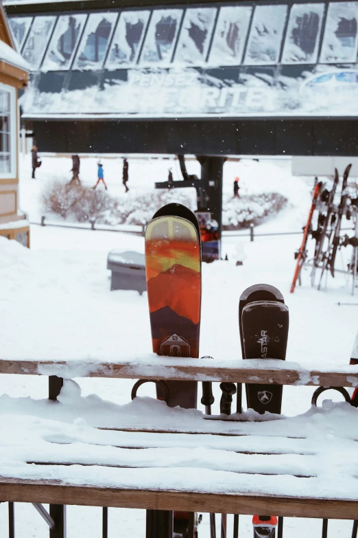 a red and black snowboard and a couple of parking meters