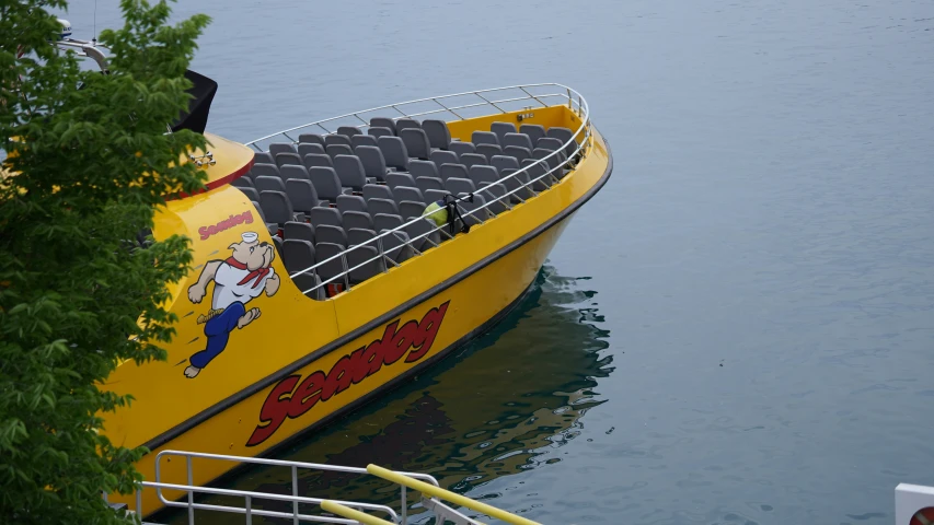 the yellow boat is parked by the side of the dock