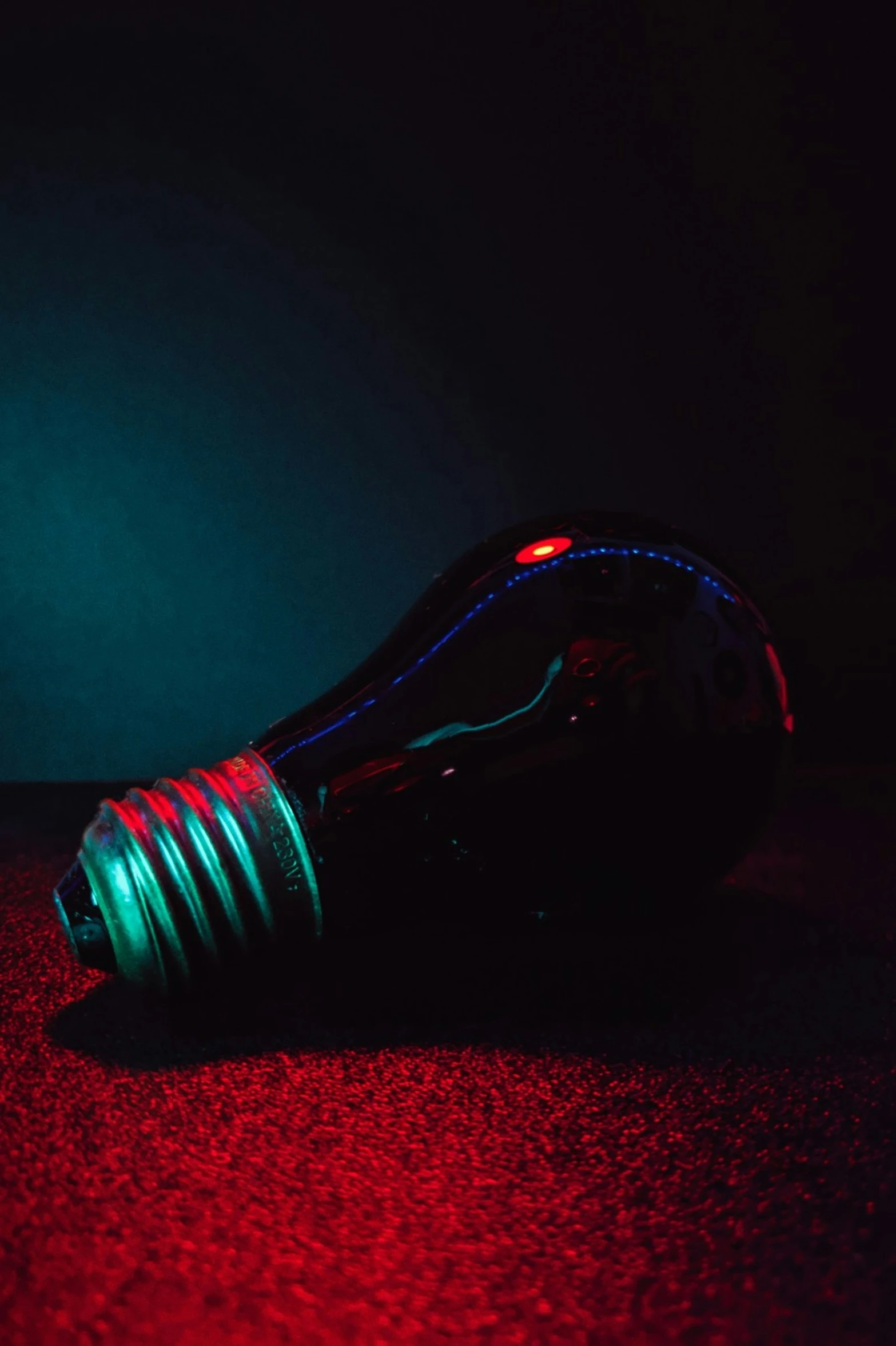 a glass bulb sitting on top of a red carpet