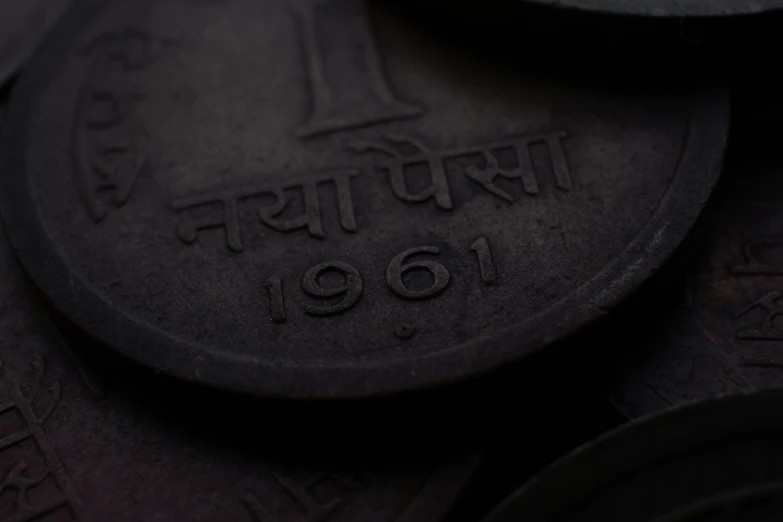 close up on a coin in india, that reads india 1909