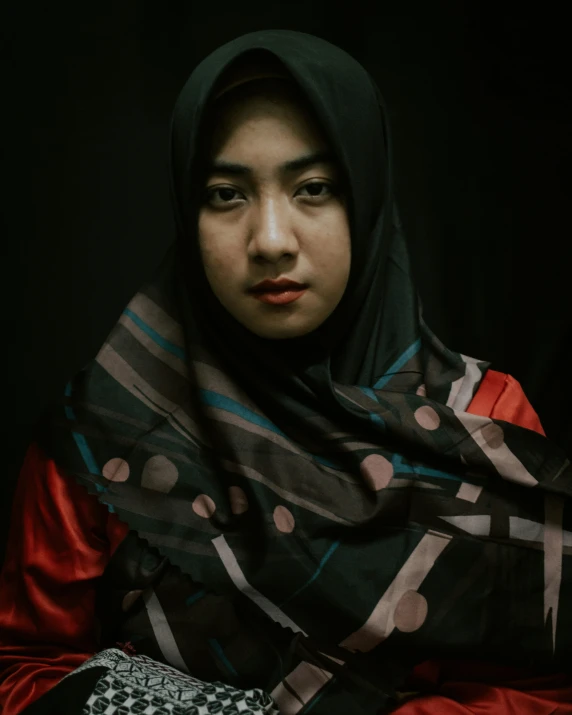 a young woman in a black shawl is posing for a po