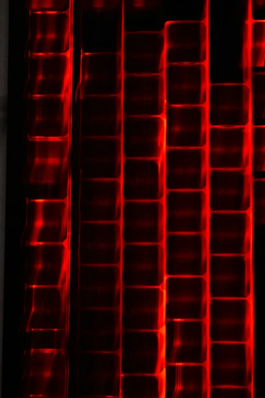 a stack of plastic bins with red lighting on the bottom and one containing food in each