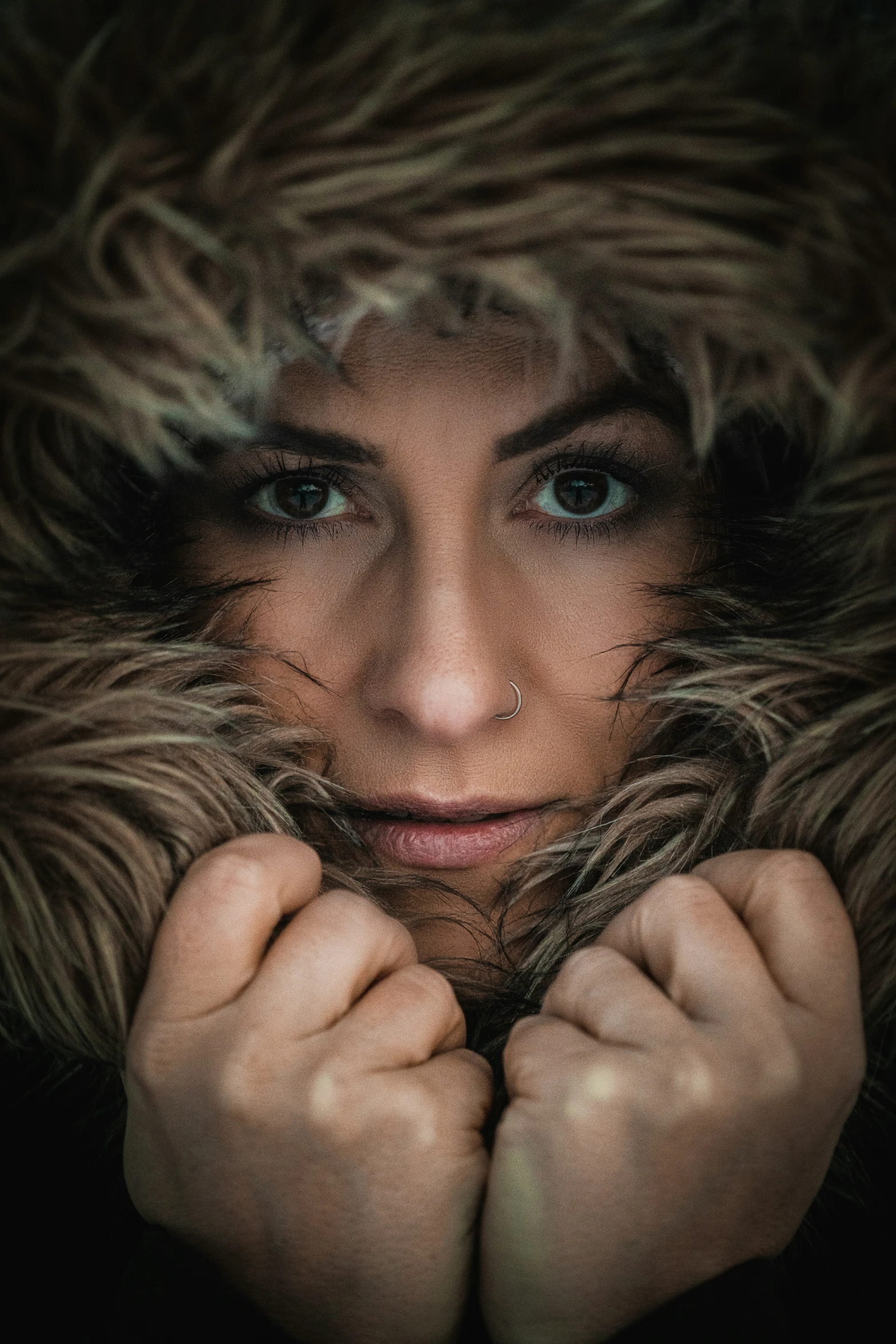 a woman in winter clothes with a fur coat over her head