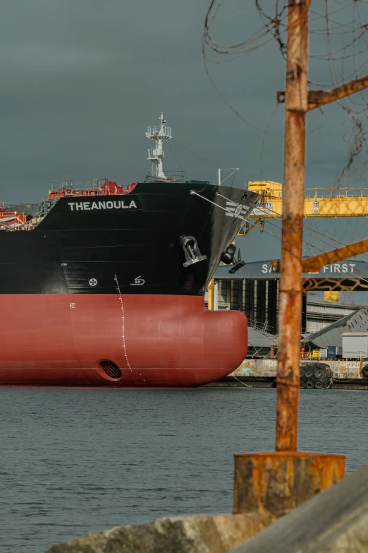 a large boat sitting in the ocean next to a boat dock