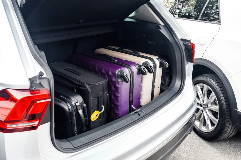 an open trunk with many luggage bags in it