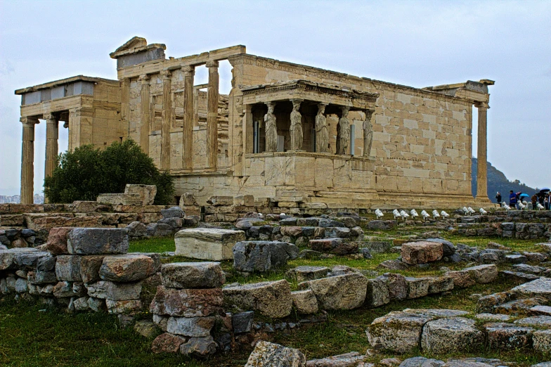 large building with columns standing in an open field