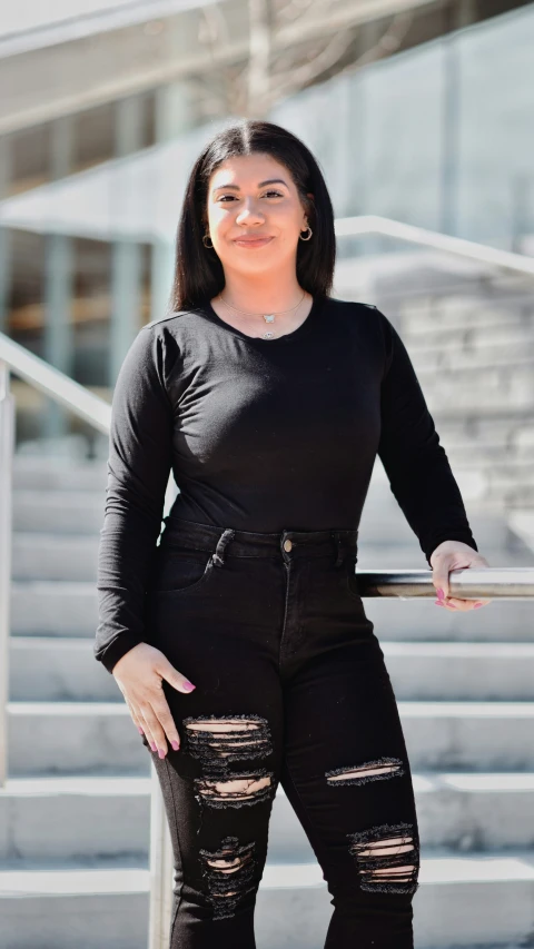 a woman with short hair and black pants