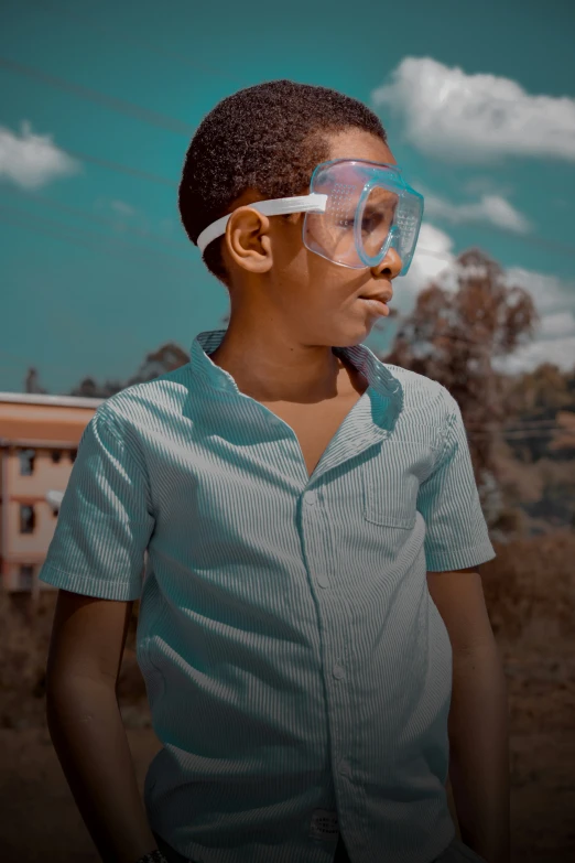 a young man wearing goggles is shown from the side