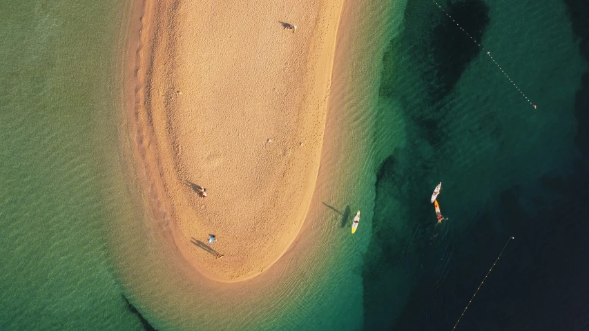 an aerial view of the ocean with a sandy beach