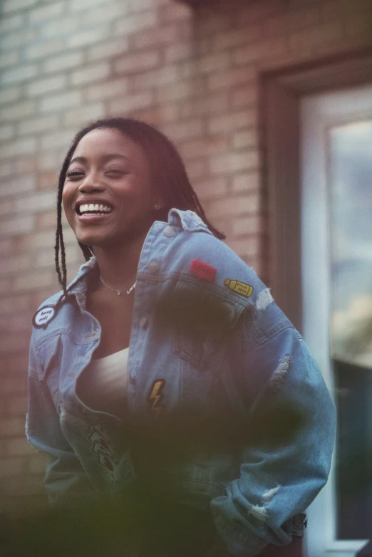 young woman smiling and leaning against the wall