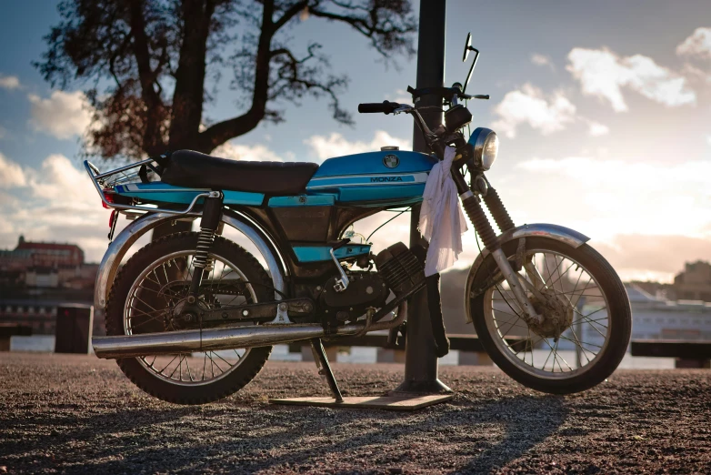 a motorcycle is shown standing in front of some trees