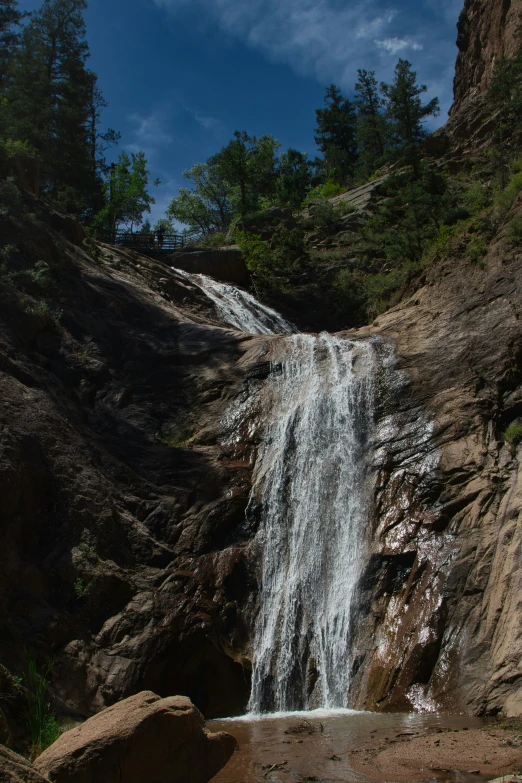 a large waterfall on the side of a cliff