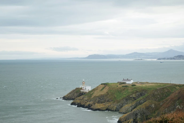 a lighthouse on a small island near the water