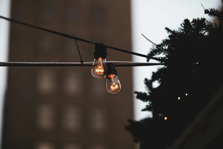 several lights hung from wires against a light pole