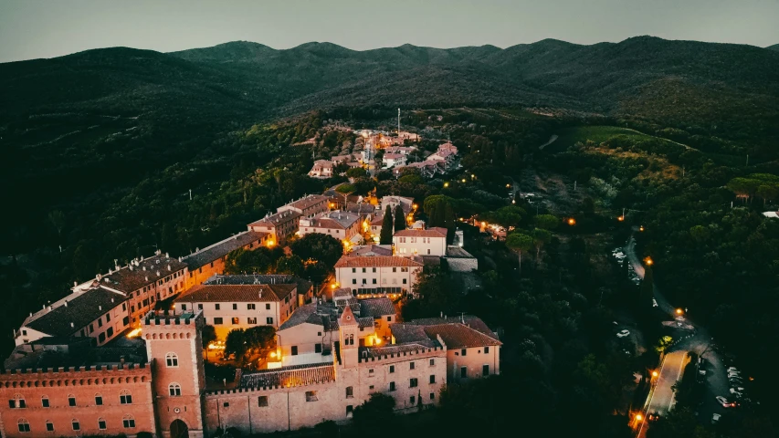 an aerial view of an old castle surrounded by hills