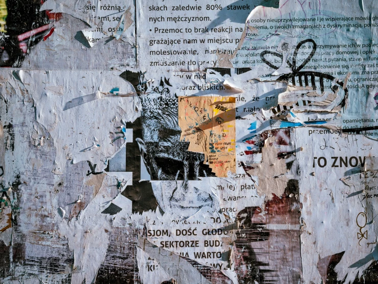 a piece of art with a variety of torn newspaper images