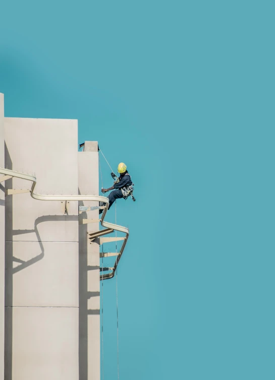 an climber on a stair belt near the top of a building