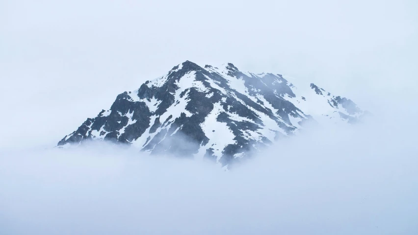 a mountain covered in snow with snow on it