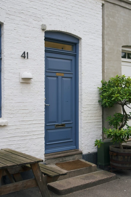 the house has two small wooden benches in front of it