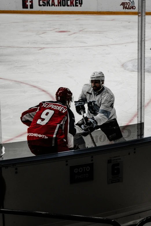 people in action on the ice near a hockey goalie