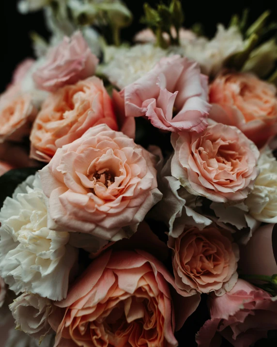 a large arrangement of pink flowers on display