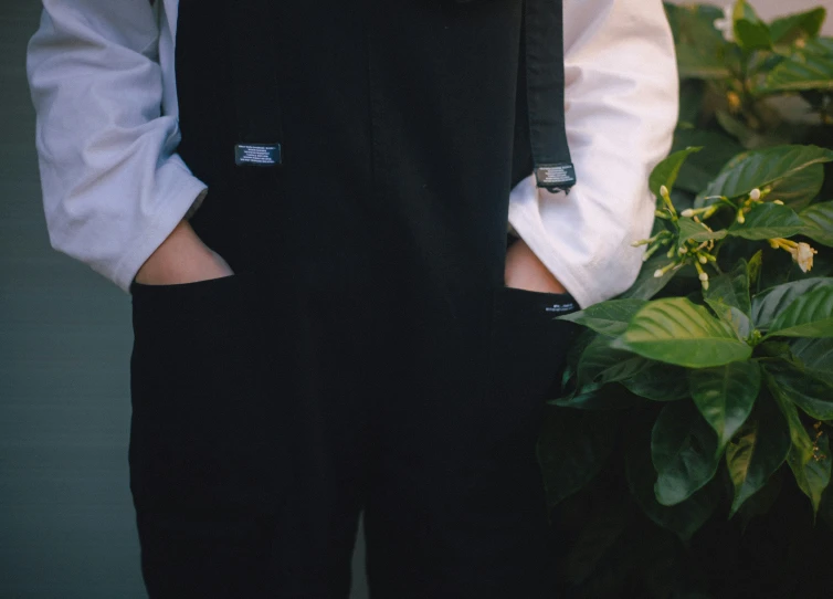 a man wearing a black tie and suspenders