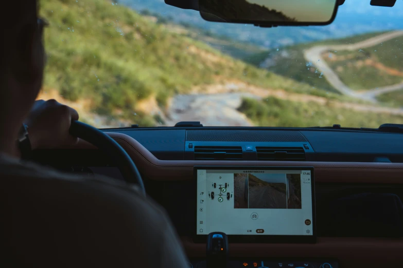 the interior of a car, with a dashboard monitor