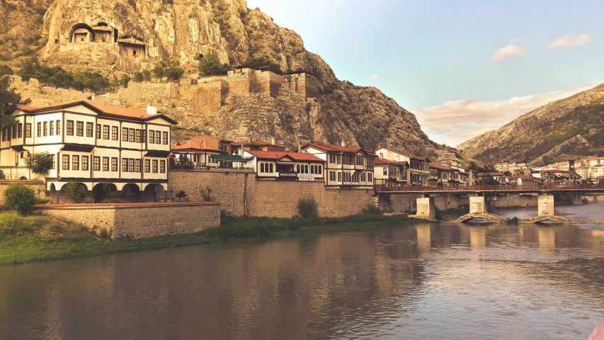 a city with tall buildings along side of a river