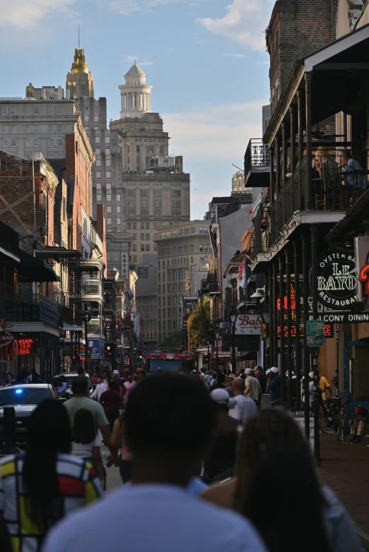 people walk in and out of a city street