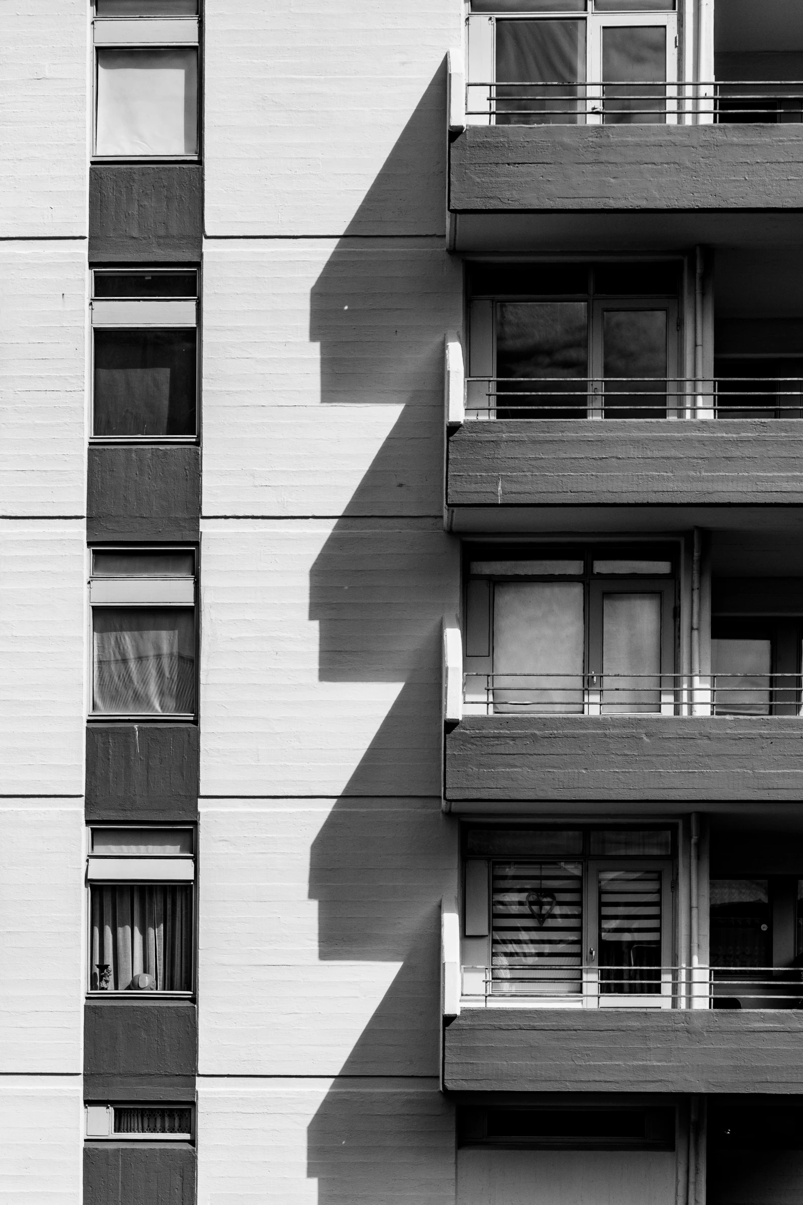 a black and white po of tall buildings with balconies