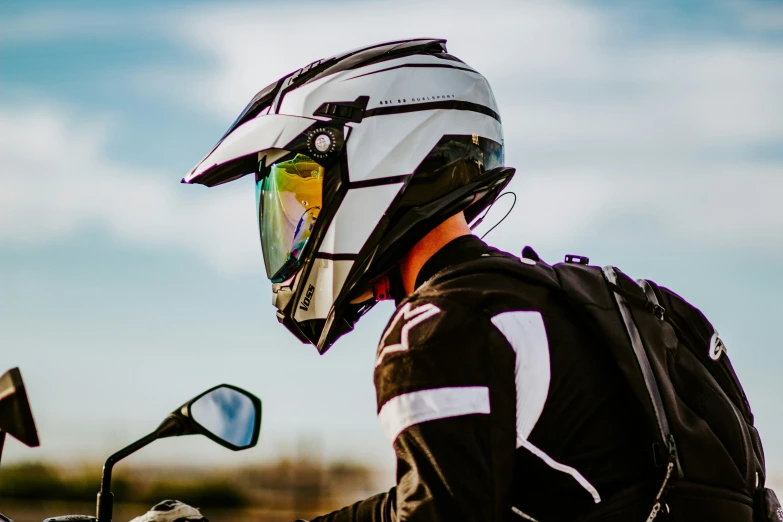 a person in a black jacket riding on a motorcycle