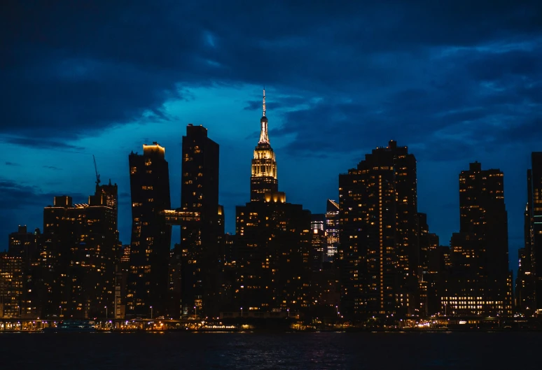 skyline view of some very tall buildings in a city at night