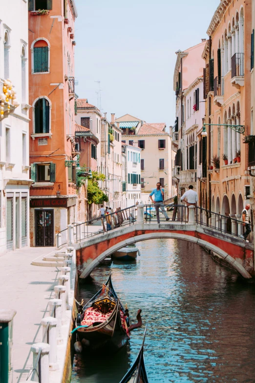 two gondolas are in the foreground and people in the background on the right side