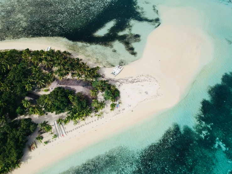 an aerial view of a tropical island and blue water