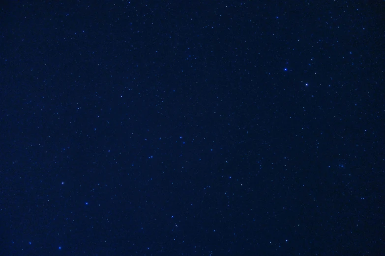 a tree in the distance surrounded by stars