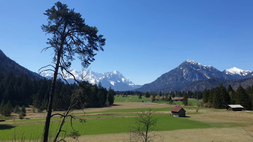 a small field near a mountain valley