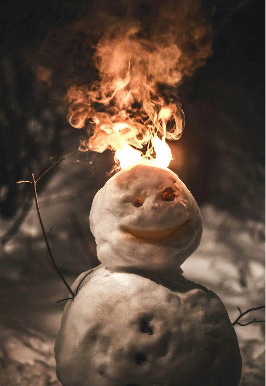 a snow man with a smile and a flame coming out of it