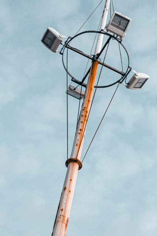 a pole with some light on it that is rusty