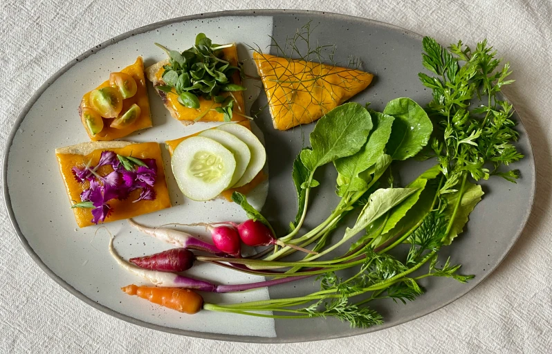 a plate of food with salads, and fruits