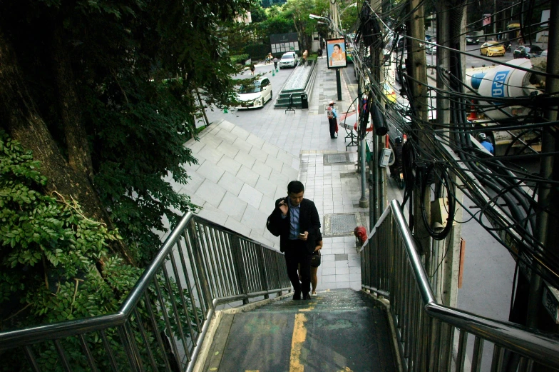 a couple of people walking down a stair case