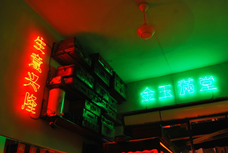 neon signs showing chinese characters on green and red lights