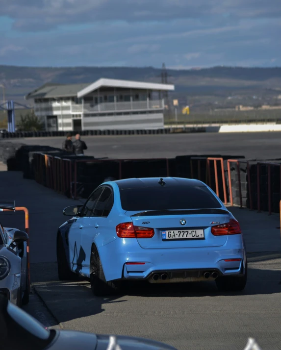 blue bmw with black license plate parked in an airport