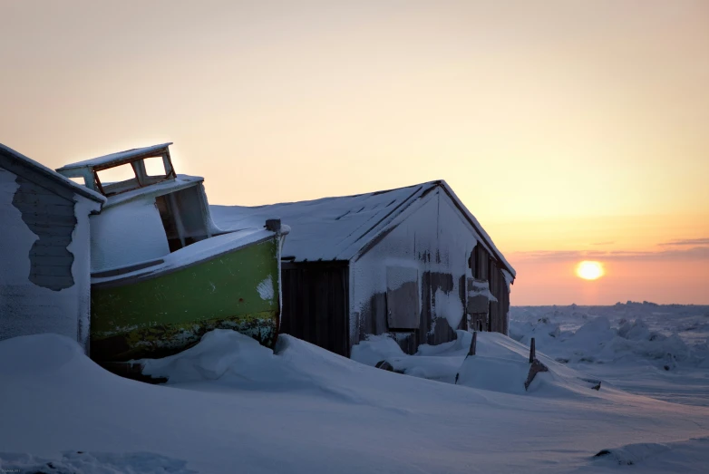 a boat is left on its side in the snow