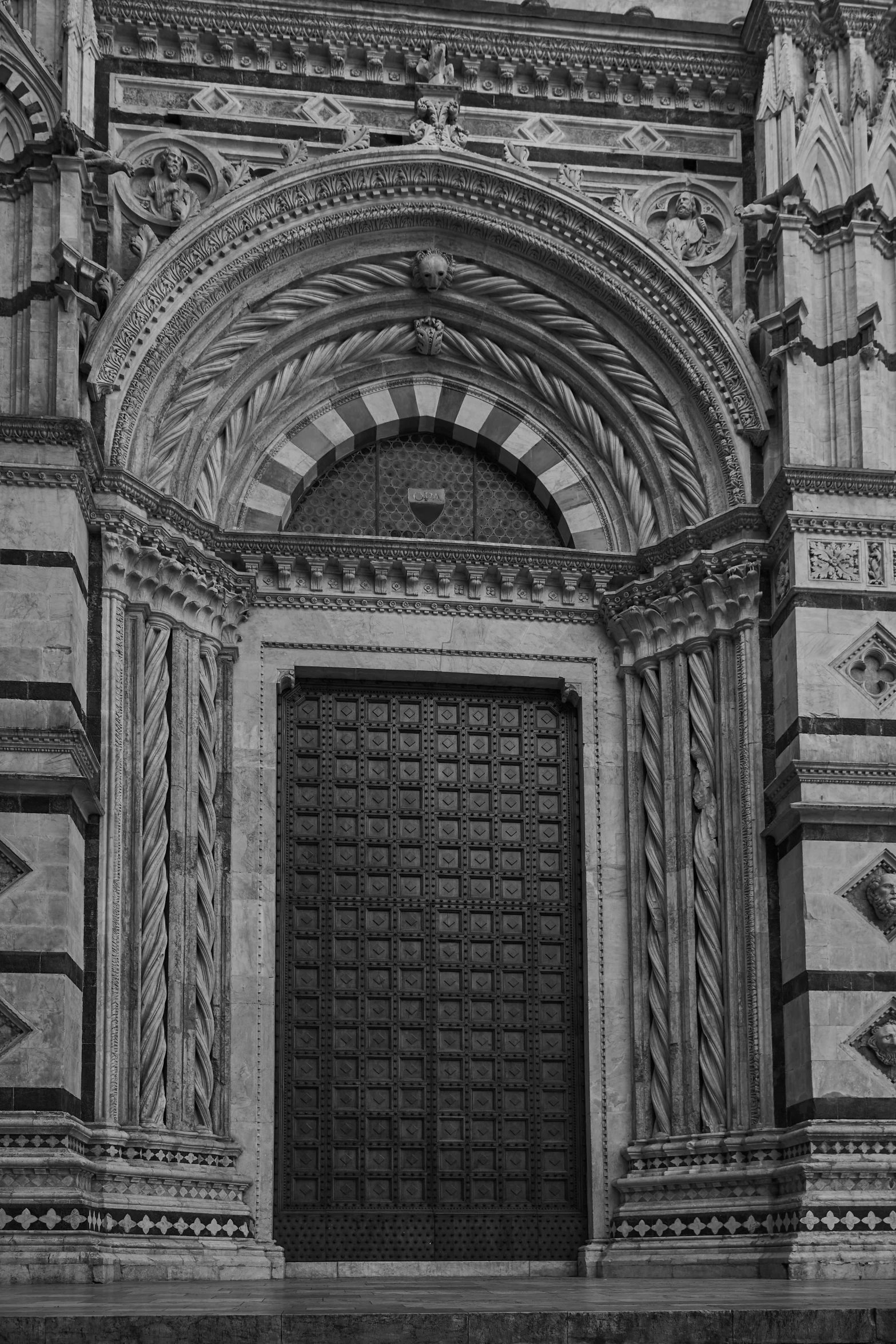 an ornate door with an arch above it