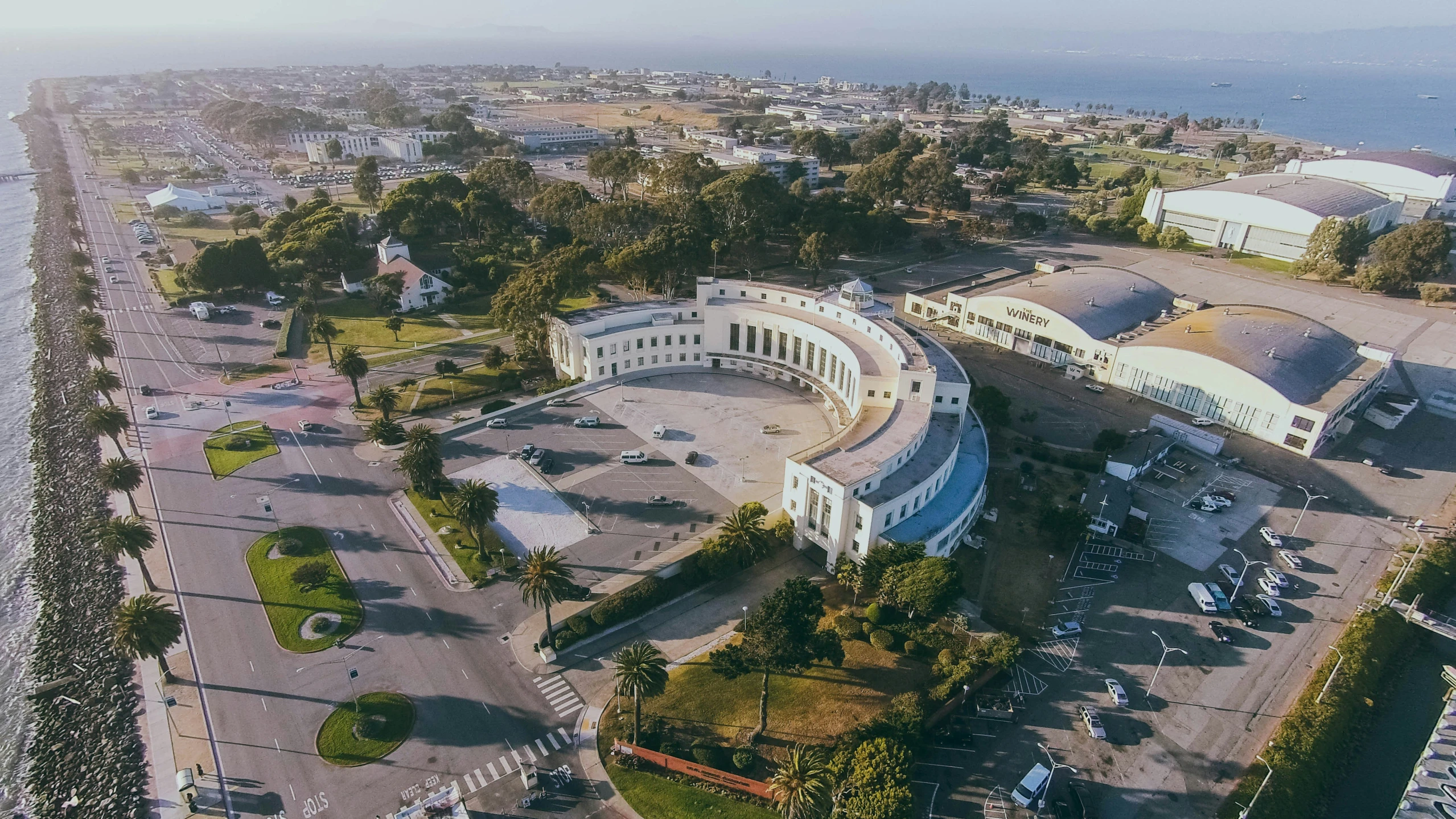 aerial view of a large building with trees and water