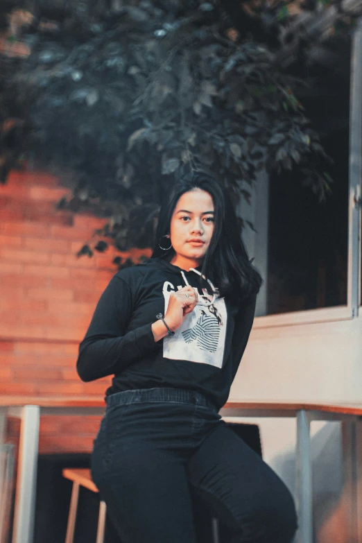 a woman wearing black is sitting down