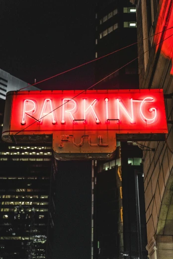 parking sign lit up on the top of building