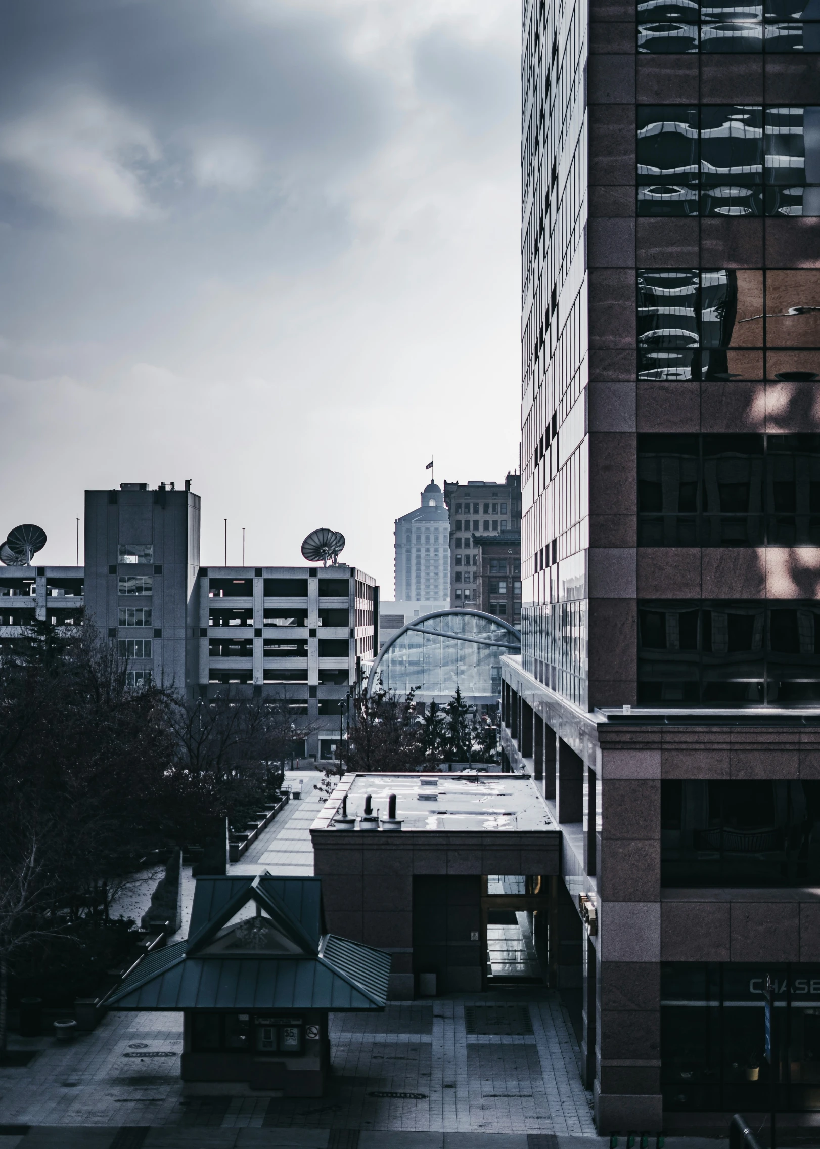 tall buildings with rooftops against an overcast sky