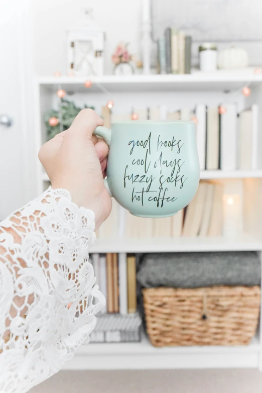 someone holding a coffee cup with a message on it