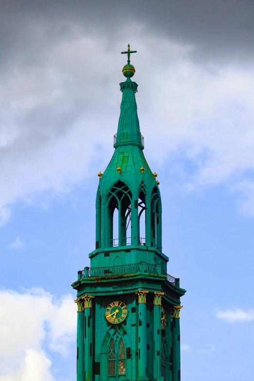 a steeple with a clock on top that is green